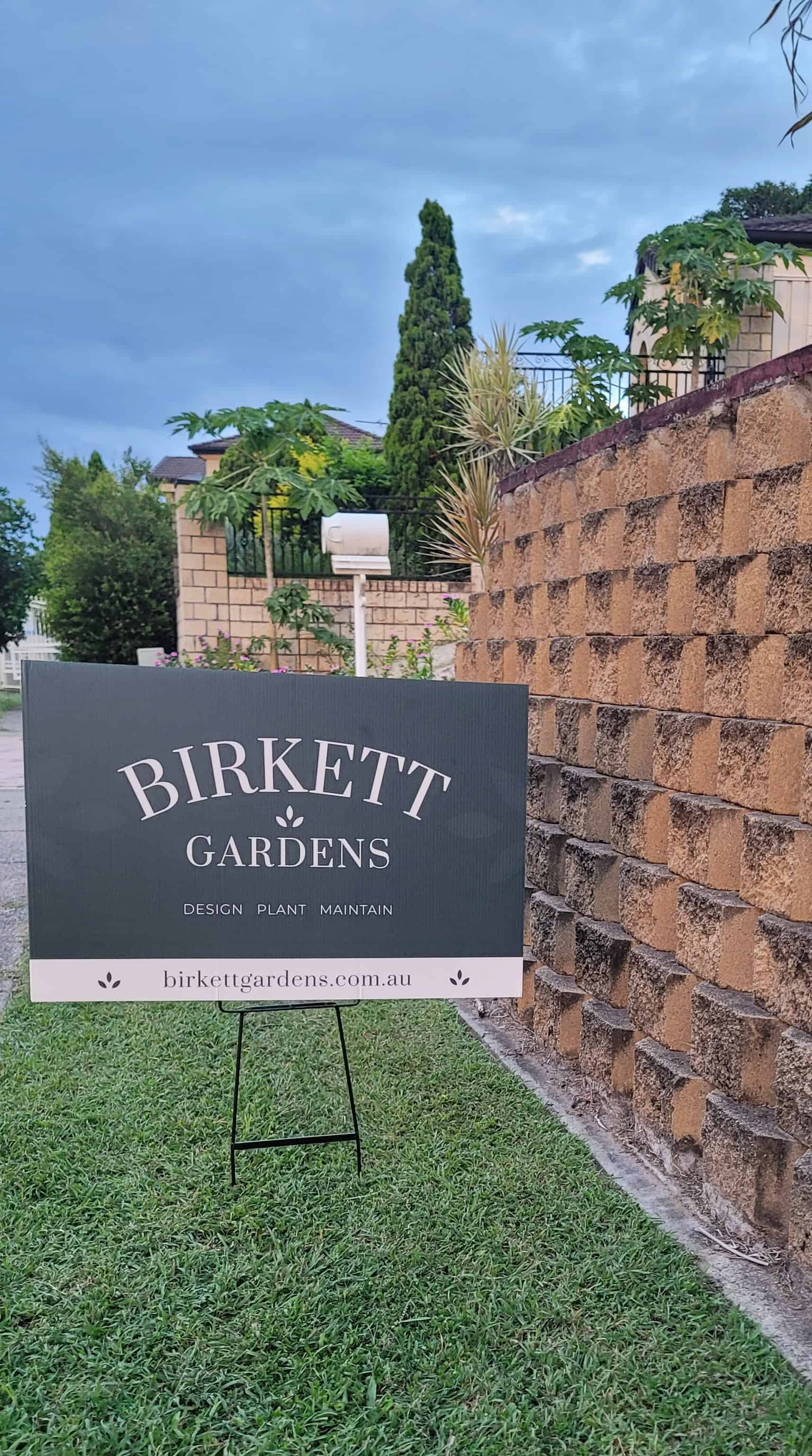 Birkett Gardens yard sign in a lawn out the front of a Brisbane garden.